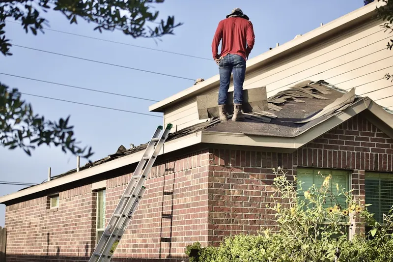 Professional roofer working on a residential roof in Sherwood Glen